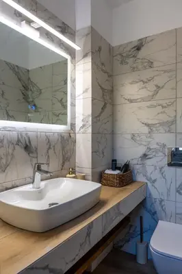 a bathroom with a white sink and a toilet at AK-Green Villa near Athens Airport in Vravrona