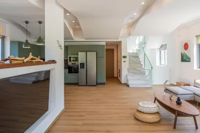 a living room with a couch and a table at AK-Green Villa near Athens Airport in Vravrona