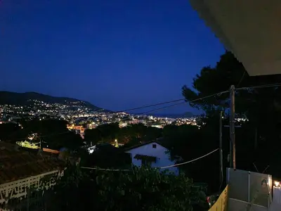a view of a city at night at Sea View House in Porto Rafti