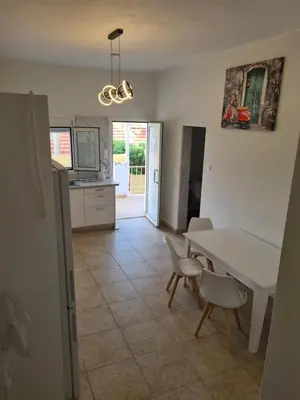 a kitchen and dining room with a table and chairs at Sea View House in Porto Rafti