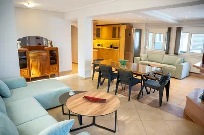 a living room with a couch and a table at Helios Apartments Porto Rafti in Porto Rafti