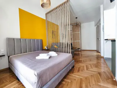 a bedroom with a bed with towels on it at Studio Σταθμός Λαρίσης 100Mbps , Μπαλκόνι in Athens
