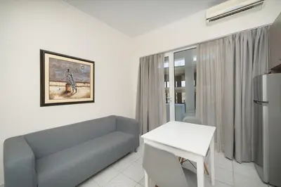a living room with a couch and a table at Bed & Flight in Markopoulo