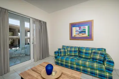 a living room with a couch and a table at Bed & Flight in Markopoulo