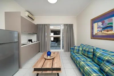 a living room with a couch and a table at Bed & Flight in Markopoulo