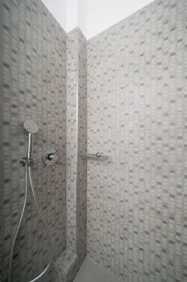 a bathroom with a shower with a glass door at Bed & Flight in Markopoulo