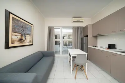 a living room with a couch and a table at Bed & Flight in Markopoulo
