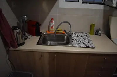 a kitchen counter with a sink with a dish towel on it at Goudi Athens Retreat in Athens