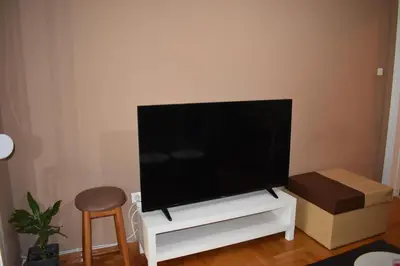 a flat screen tv sitting on a white entertainment center at Goudi Athens Retreat in Athens