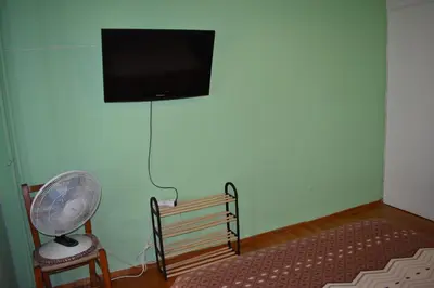 a room with a fan and a tv on a wall at Goudi Athens Retreat in Athens