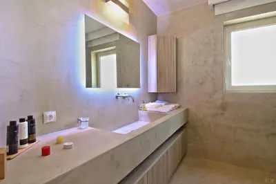 a bathroom with a sink and a mirror at Villa Nelmar in Anavissos