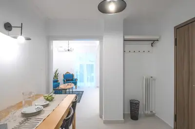 a white kitchen with a table and a dining room at Archive, The Art of Living in Athens
