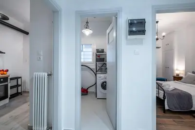 a white room with a bedroom and a bed at Archive, The Art of Living in Athens