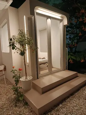 a staircase with a mirror and a potted plant at Viktoria's Garden Pavilion in Athens