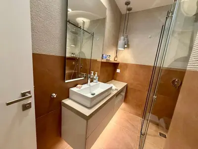 a bathroom with a sink and a shower at Diana Seaside Apartment in Anavissos
