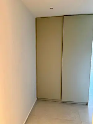 an empty room with two sliding doors in a building at Diana Seaside Apartment in Anavissos