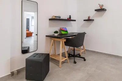 a desk in a room with a chair and a mirror at Φωτεινό σπίτι 200μ από την παραλία in Porto Rafti