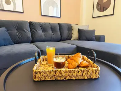 a table with a tray of bread and orange juice at Cosy apartment next to Larissa station 100Mbps & Balcony in Athens
