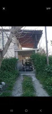 a garage with a car parked under a building at Pallini house in Pallíni