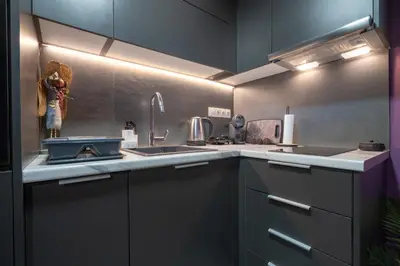 a kitchen with gray cabinets and a sink at Lilac Dream in Glyfada by ΜΡS in Athens