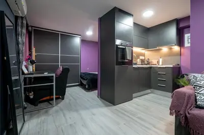 a room with purple walls and a kitchen with a desk at Lilac Dream in Glyfada by ΜΡS in Athens