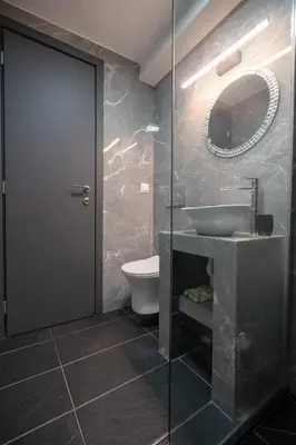 a bathroom with a sink and a toilet and a mirror at Lilac Dream in Glyfada by ΜΡS in Athens