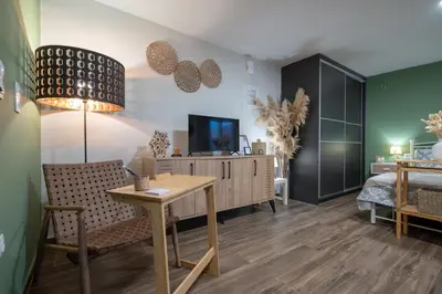 a bedroom with a desk and a bed and a tv at Boho Nest in Glyfada by ΜΡS in Athens