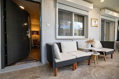 a porch with two chairs and a table at Boho Nest in Glyfada by ΜΡS in Athens