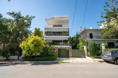 a building with a car parked in front of it at Boho Nest in Glyfada by ΜΡS in Athens