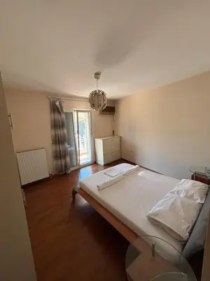 a bedroom with a large bed and a table at Elegant Flat in Elliniko with Sea View & Parking in Athens