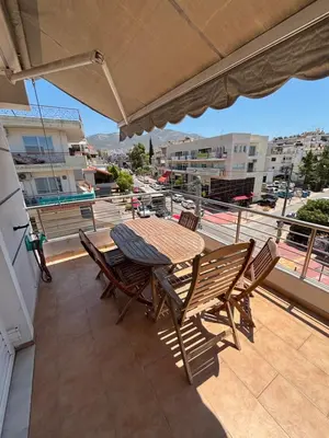 a table and chairs on a balcony with a view at Elegant Flat in Elliniko with Sea View & Parking in Athens