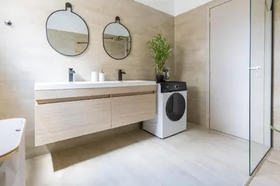 a bathroom with a sink and a washing machine at Raise Coastal Grand Escape in Athens