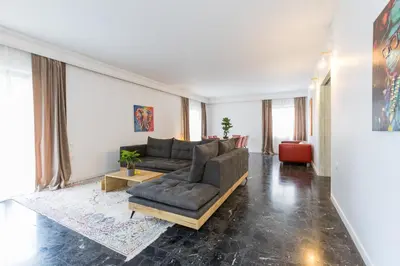 a living room with a couch and a table at Raise Coastal Grand Escape in Athens