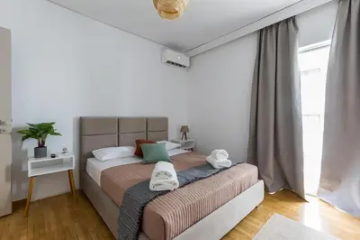 a bedroom with a bed with towels on it at Raise Coastal Grand Escape in Athens