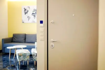 a living room with a blue couch and a table at The Brightline Apartment Athens in Athens