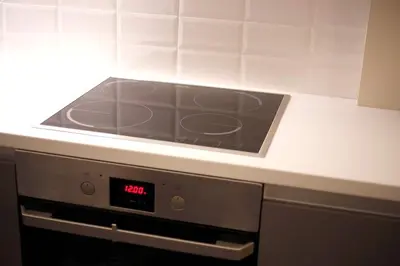 a stove top oven with a clock on it at The Brightline Apartment Athens in Athens