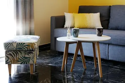 a living room with a table and a couch at The Brightline Apartment Athens in Athens
