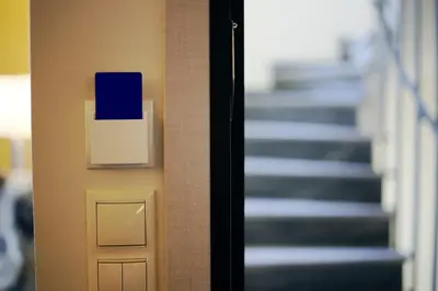 a hallway with stairs and a blue box on a wall at The Brightline Apartment Athens in Athens