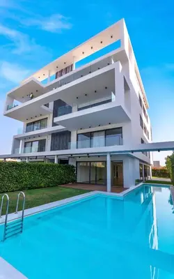 a building with a swimming pool in front of it at Athens Riviera, 2 Pools & Gym Luxury Residence 310m2 in Athens