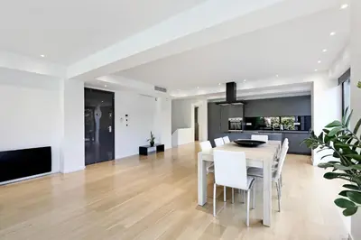 a kitchen and dining room with a white table and chairs at Athens Riviera, 2 Pools & Gym Luxury Residence 310m2 in Athens