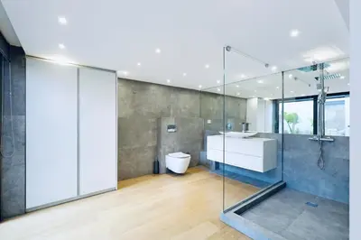 a bathroom with a sink and a glass shower at Athens Riviera, 2 Pools & Gym Luxury Residence 310m2 in Athens
