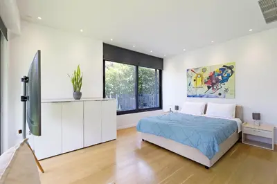 a bedroom with a bed and a large window at Athens Riviera, 2 Pools & Gym Luxury Residence 310m2 in Athens