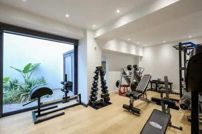 a gym with tread machines and a large window at Athens Riviera, 2 Pools & Gym Luxury Residence 310m2 in Athens