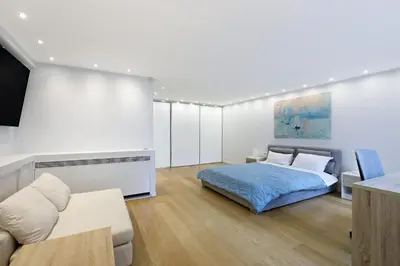 a bedroom with a bed and a couch at Athens Riviera, 2 Pools & Gym Luxury Residence 310m2 in Athens
