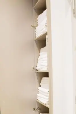 a closet filled with lots of white towels at Acropolis Luxury retreat in Athens