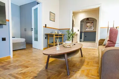 a living room with a table and a couch at Acropolis Luxury retreat in Athens