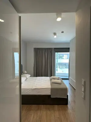 a bedroom with a large bed and a window at Niarchos Elegant Maisonette in Athens