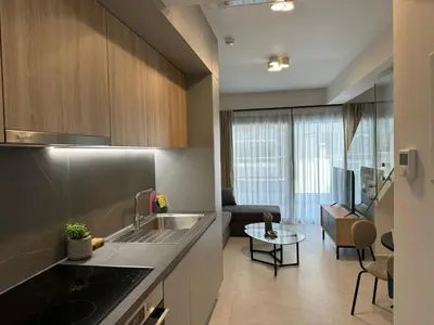 a kitchen with a sink and a living room at Niarchos Elegant Maisonette in Athens