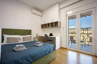 a bedroom with a bed with towels on it at Traveler's Dream 3-Bedroom Renovated Penthouse in Athens