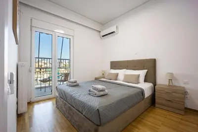 a bedroom with a bed with two towels on it at Traveler's Dream 3-Bedroom Renovated Penthouse in Athens